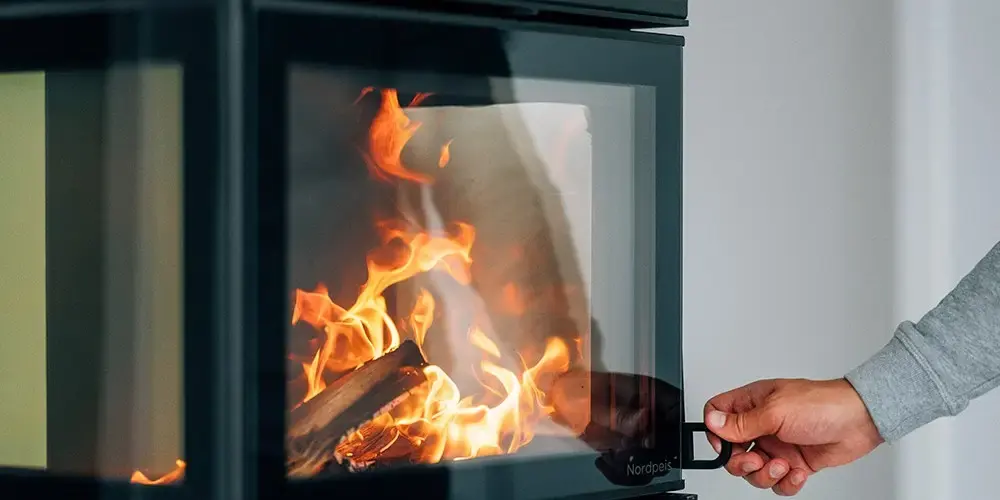 Nærbilde av en ny, moderne peis med levende flammer fra Peisbutikken.no, perfekt for en koselig atmosfære i hjemmet.