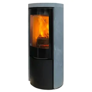 En Jydepejsen Cozy Modern Klebrestein peisovn står mot en hvit bakgrunn, og viser en slank sort base og en teksturert grå kleberstein øvre del, med en stor panoramisk glassdør som avslører livlig vedfryt som brenner inni. Peisovnens kurvede silhuett og robuste konstruksjon fremhever dens moderne design, med flammene som kaster en varm glød gjennom glasset, og understreker dens funksjonelle og dekorative appell.